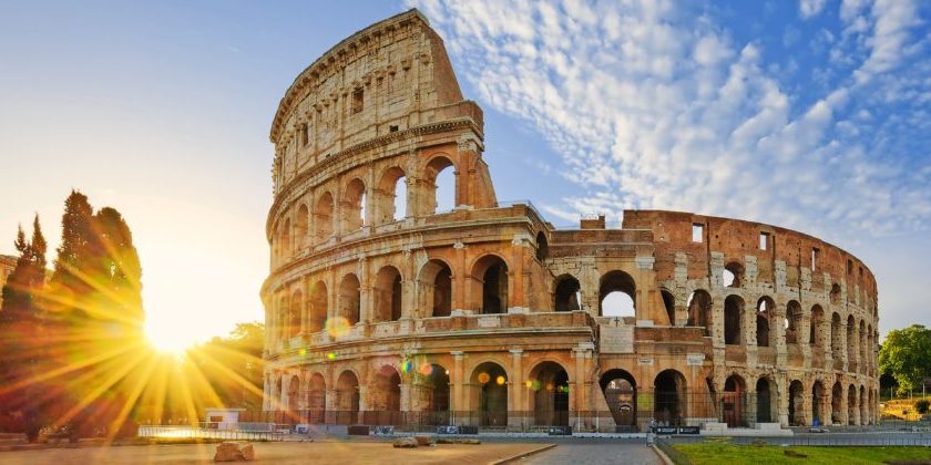 Panoramic view of Colosseum in Rome and morning sun, Italy, Europe.