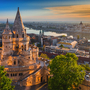 Fischerbastei in Budapest bei Sonnenuntergang mit Blick auf die Donau und das Parlament.