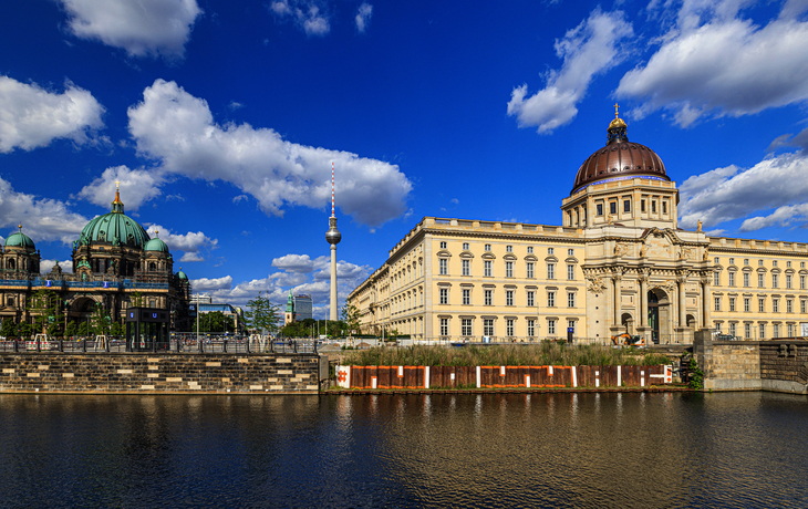Berliner Dom und Stadtschloss an der Spree, blauer Himmel mit Wolken.